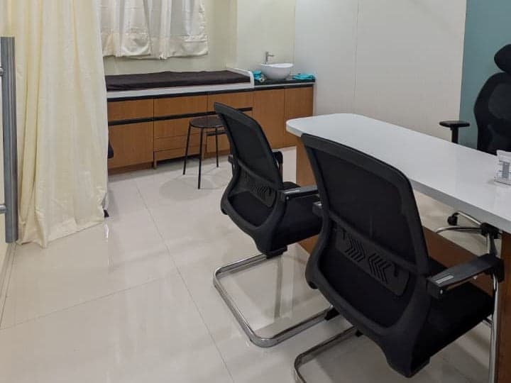 Consulting room with examination couch, wash basin and consultation desk at the rheumatology clinic in Ravet