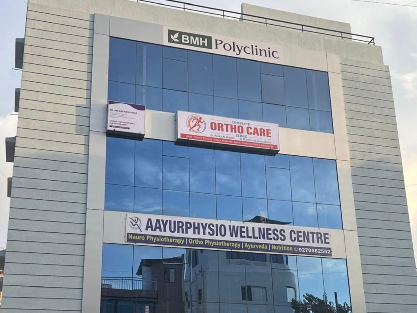 BMH Polyclinic building at Shinde Vasti Chowk, Ravet, with the signboard for Dr. Abhijeet Bhosikar, Consultant Physician & Rheumatologist