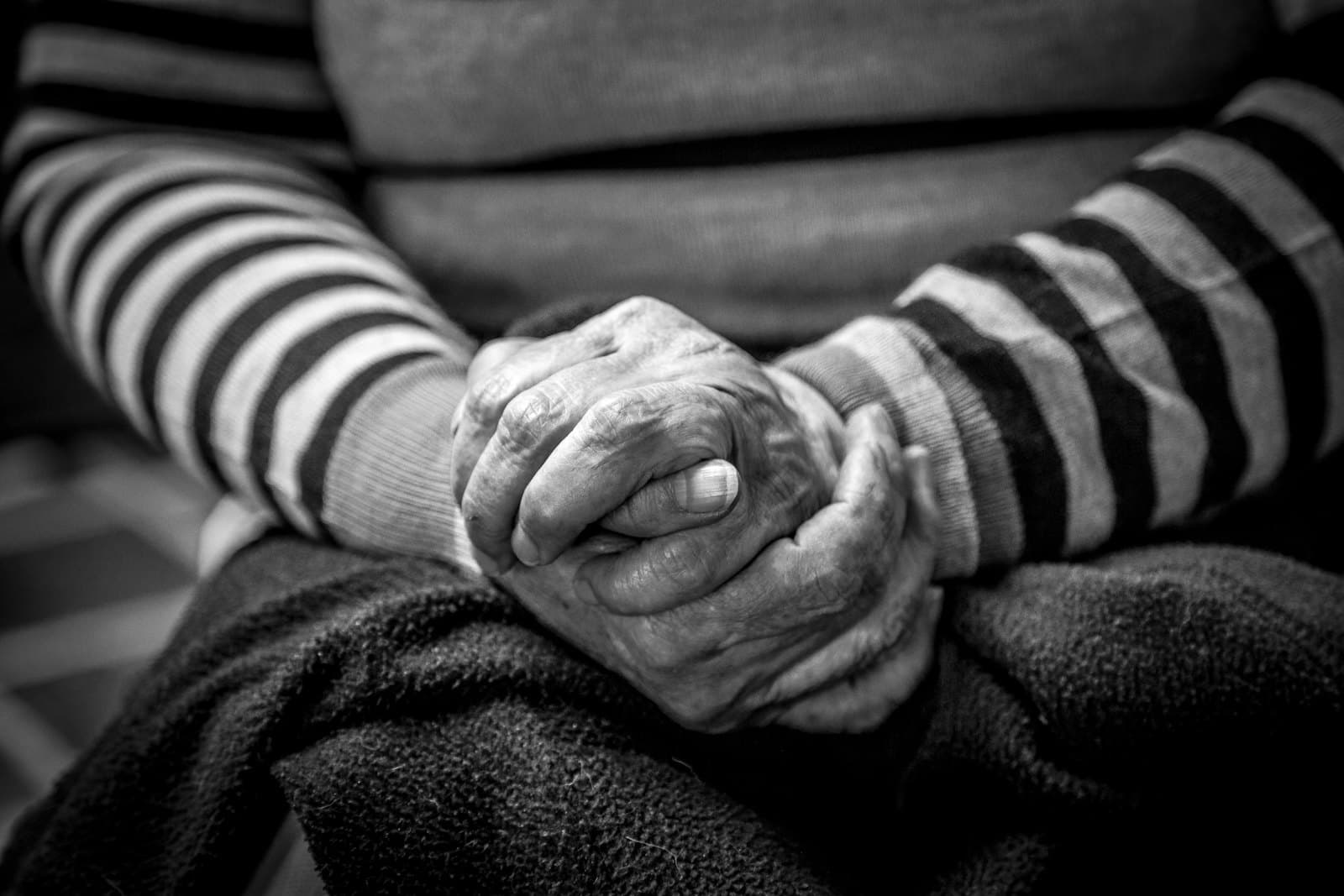 Close-up of a pair of older hands resting together