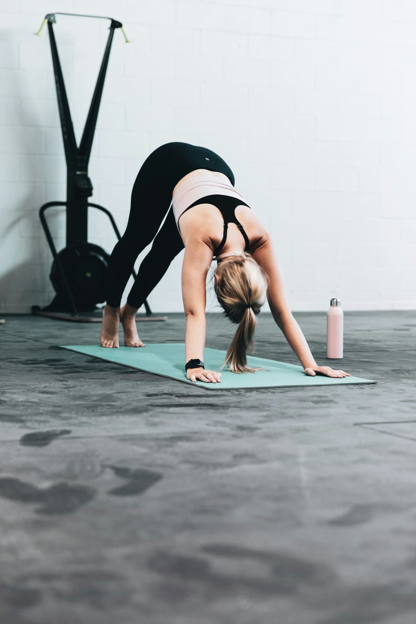 A person stretching forward on an exercise mat