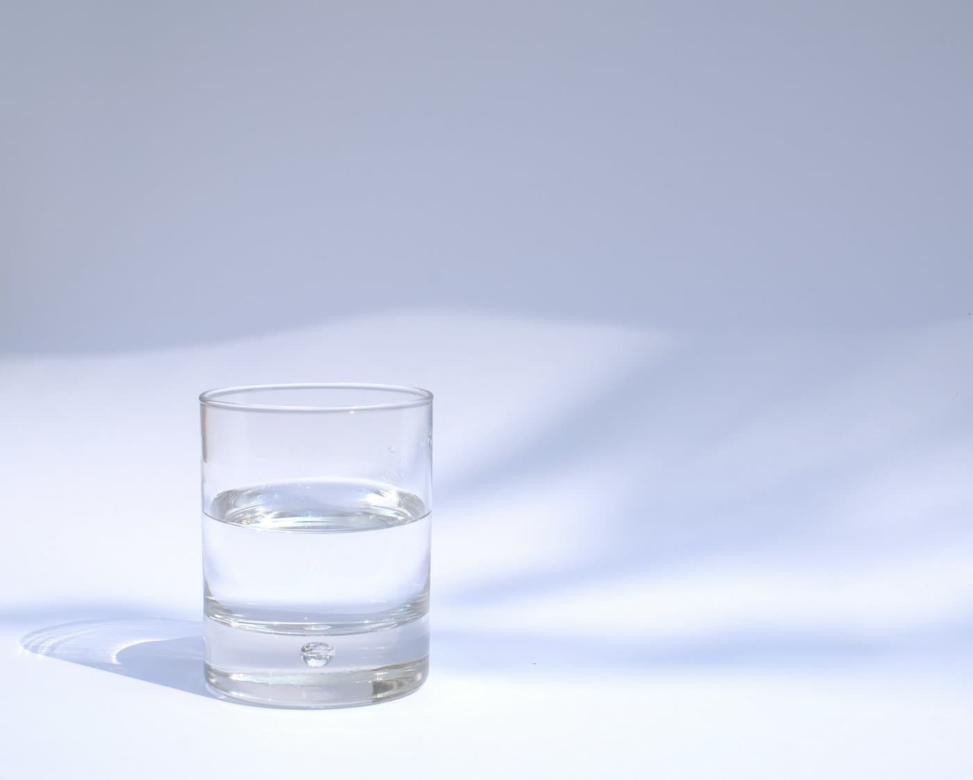 A glass of water on a pale surface